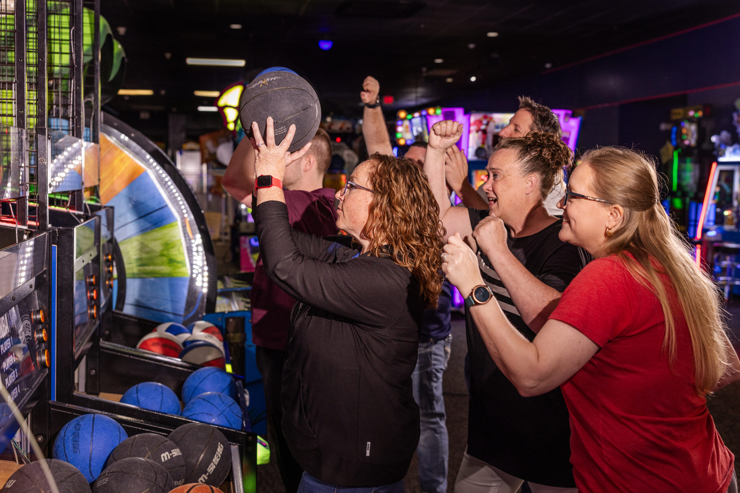 Team-Building Fun at America’s Incredible Pizza Company Arcade Adults cheering and playing arcade basketball at America’s Incredible Pizza Company during a group event