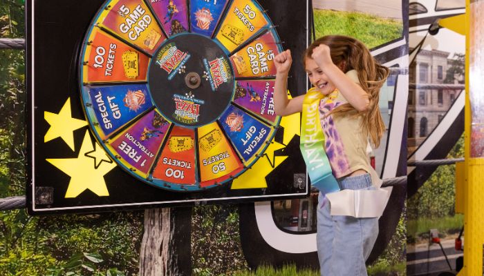 Guests spinning the prize wheel at Incredible Pizza